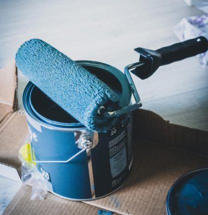 paint roller sitting on paint can