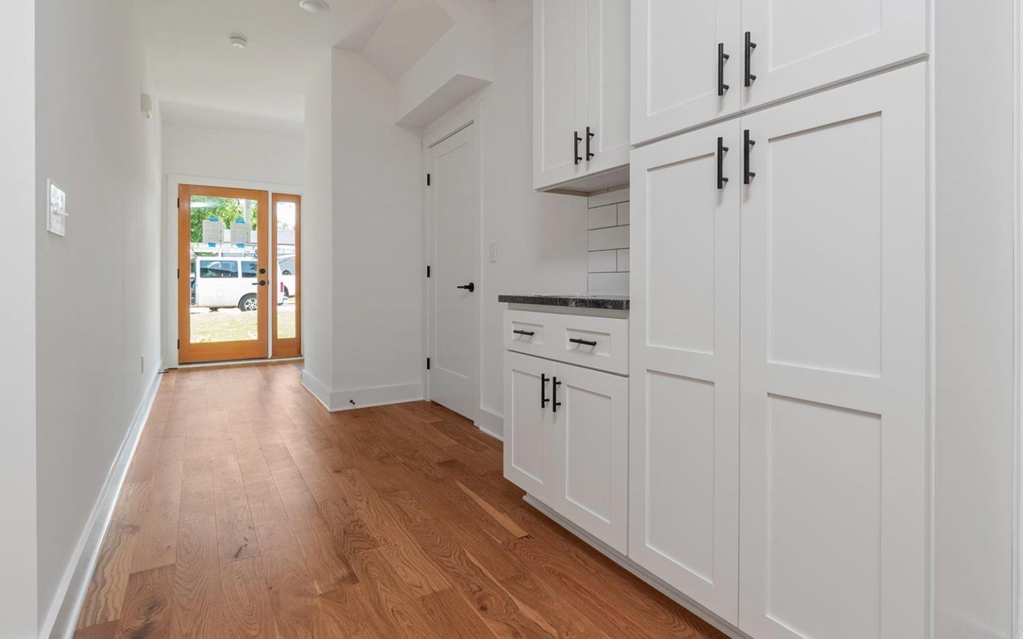 freshly painted kitchen cabinets in long bright hallway