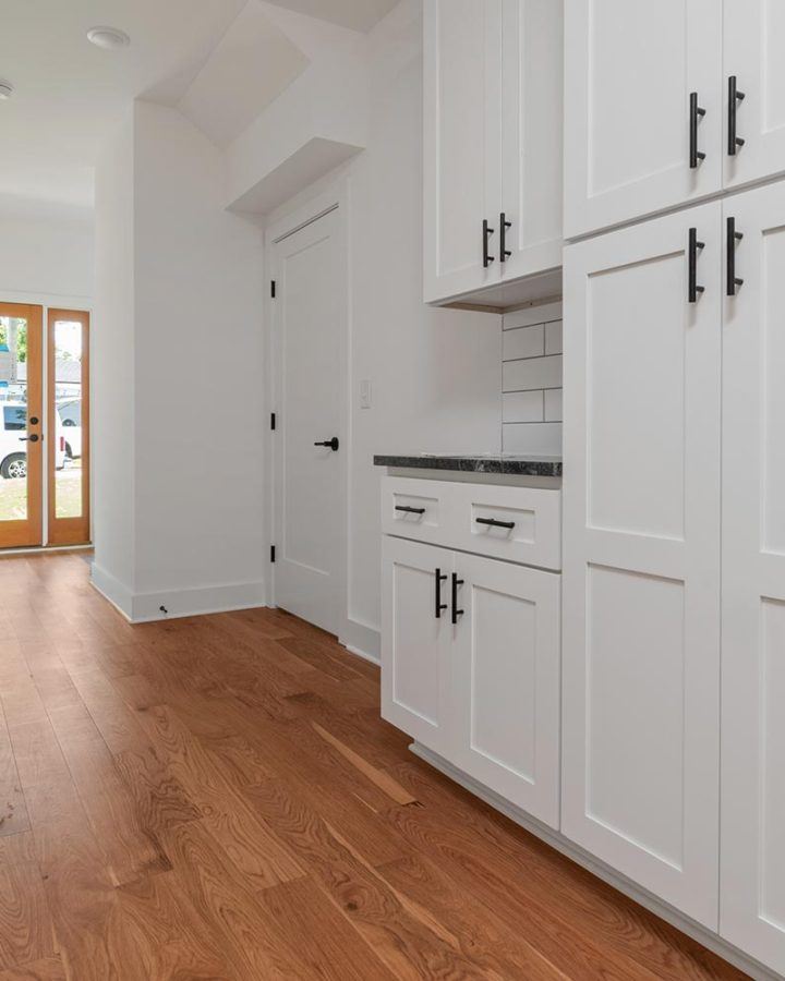 freshly painted kitchen cabinets in long bright hallway